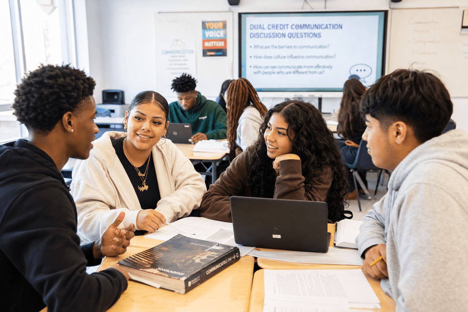 Diverse group of Black and Hispanic high school students collaborating in a bright classroom during a dual credit communication discussion